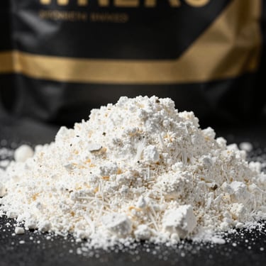 Macro shot of fine white whey protein isolate powder, sleek black packaging with subtle gold accents in the background, dramatic studio lighting