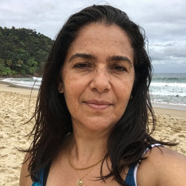 Smiling mother holding her peacefully sleeping baby in a cozy nursery.