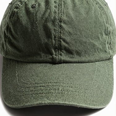 Front-facing product shot of a Cambridge relaxed cotton dad hat in olive green, textured fabric, natural side light, 50mm lens