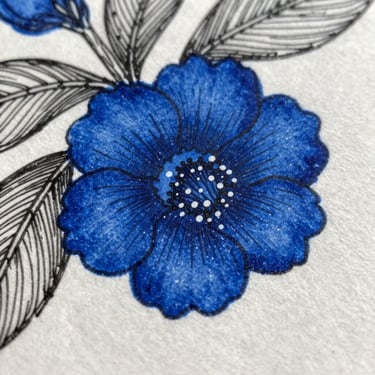 Extreme close-up of botanical illustration detail, individual ink marks and cross-hatching visible against the paper grain, a concentrated patch of vivid cobalt blue surrounded by fine black linework, macro photography under raking natural light
