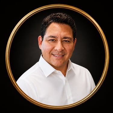 Professional headshot of a smiling man in a white shirt framed by a gold circle on black.