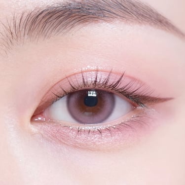 Macro close-up of a perfectly lifted eyelash, clean skin, soft pink ambient light, editorial beauty photography