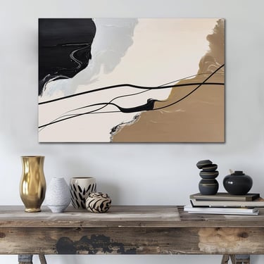 Modern abstract canvas wall art with black, beige, and gold brushstrokes hanging above a rustic wooden console table.