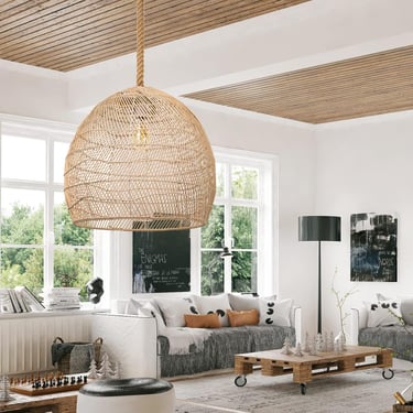 Bohemian living room featuring a large woven rattan pendant light and rustic wood pallet coffee table.
