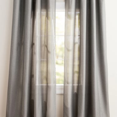 Modern grey linen grommet curtains hanging on a window for elegant home decor and privacy.