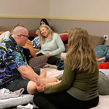 People cuddling with lots of blankets and pillows HCC 2026. Photo by Cheryl V