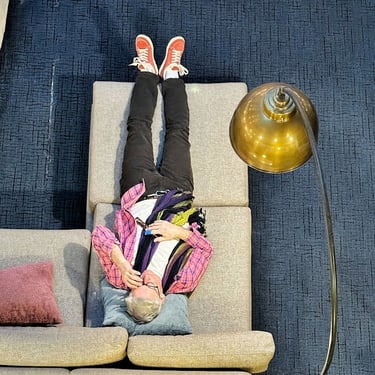 person reclining on couch taken from above at HCC 2026. Photo by Cheryl V