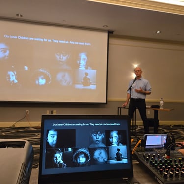 Tom presenting at HCC 2026 inner child slide. photo by Kassandra B