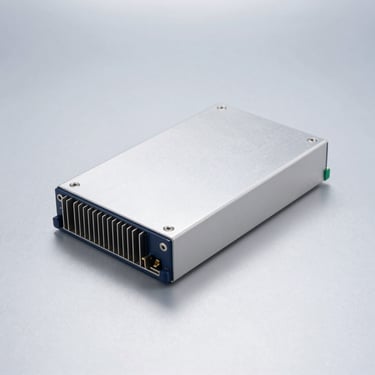 Fanless embedded industrial box PC with aluminum heatsink, solid clinical light-gray metallic background, cold studio lighting.