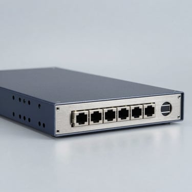 Rackmount industrial network appliance with steel front panel, on a solid clinical light-gray metallic background