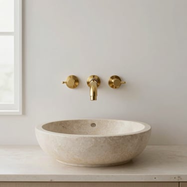 Symmetrical shot of a clean vanity unit installation, featuring a perfectly sealed stone basin and premium wall-mounted brassware