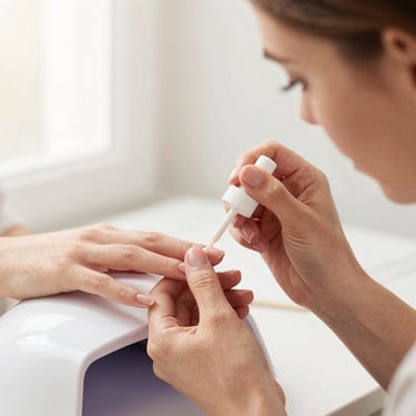Nail artist applying a flawless high-gloss gel top coat under a UV LED lamp, bright editorial photography, soft natural window light, warm neutral tones, crisp focus.