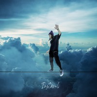 a man walking on a tight rope with his hands up