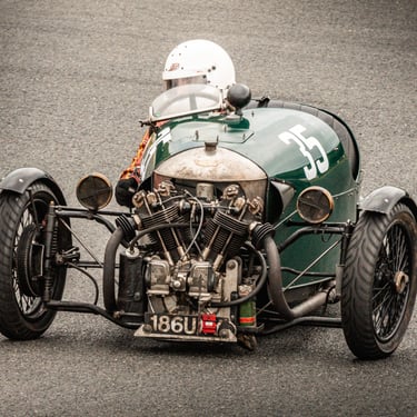 Vintage three-wheeler racing car on track photographed by Mike Barrett