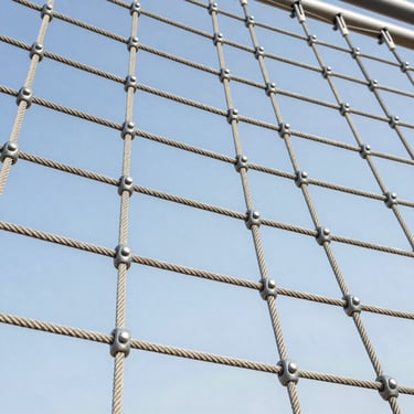 Close-up of a heavy-duty rope climbing net with solid aluminum connectors, high tension, outdoor playground setting