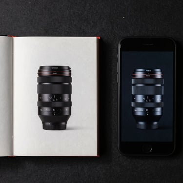 Precise overhead flat-lay of a physical book alongside its digital counterpart on a screen, sharp shadows, technical layout.