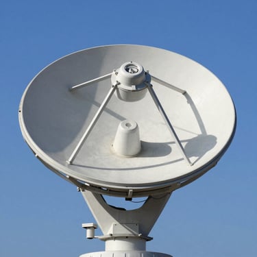 A professional satellite dish aligned perfectly against a clear blue sky, metallic texture