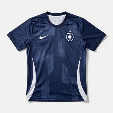 Flat-lay presentation of a premium sublimated athletic jersey, deep navy and white geometric patterns, clean studio lighting.