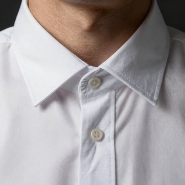 Close-up of a crisp corporate oxford shirt collar, precise stitching detail, elegant minimalist presentation.