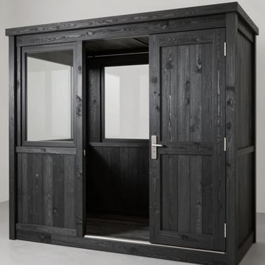 A compact timber guard room with secure windows and a robust door, showing off professional wood treatment in a deep charcoal shade.