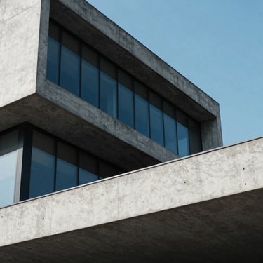 Modern concrete architectural office exterior, sharp geometric lines, cool daylight, high contrast
