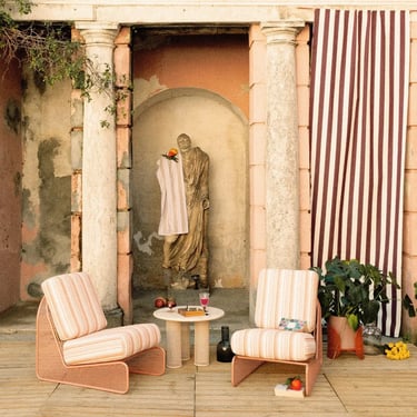 Striped outdoor cushions on lounge chairs adding softness, color and warmth to a cozy patio seating