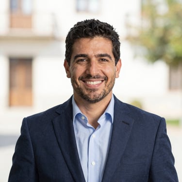 Professional headshot of Rafael Valero, local representative of Guadarrama, smiling, bright natural background, professional attire