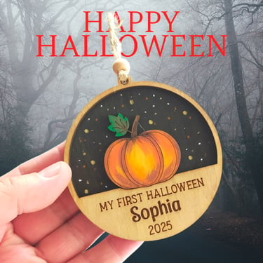 a wooden Hallowen bauble with a pumpkin