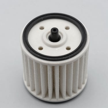 Macro shot of a clean spin-on oil filter with visible rubber gasket, studio lighting, gray background