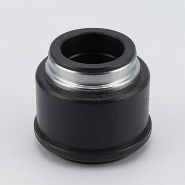 Crisp studio shot of a black rubber control arm bushing with metal sleeve, light gray background