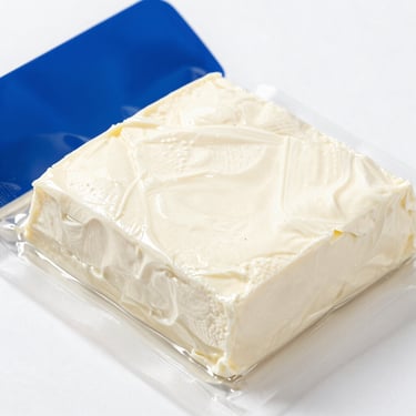 Blocks of fresh vacuum-packed paneer showing soft uniform texture, bright clinical lighting