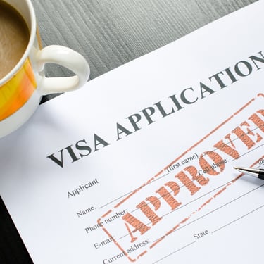 Visa application with an approved stamped on top.
