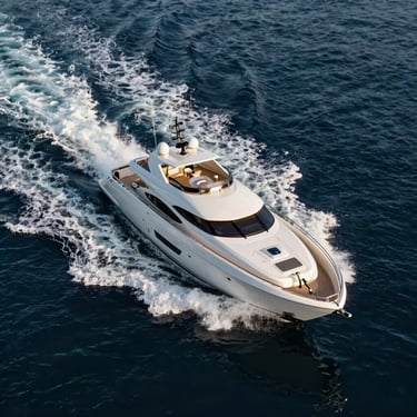 Aerial high-contrast shot of a sleek modern superyacht cruising through deep indigo waters, white wake cutting the sea, golden hour.