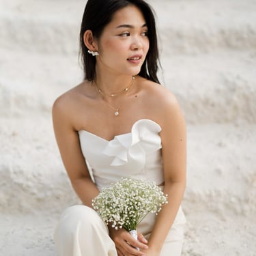 Bride portrait holding bouquet during bridal party session at Melasti Beach Bali