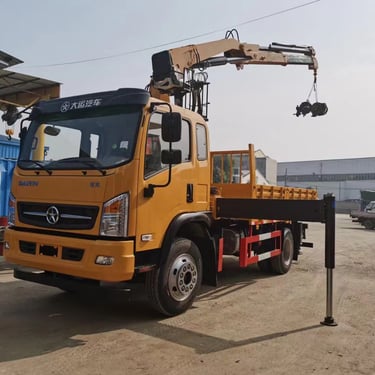Yellow truck with knuckle loader crane on top.