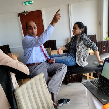 Dr. Prabal teaching and explaining chronic pain therapy to a patient at a medical camp in Blackpool.