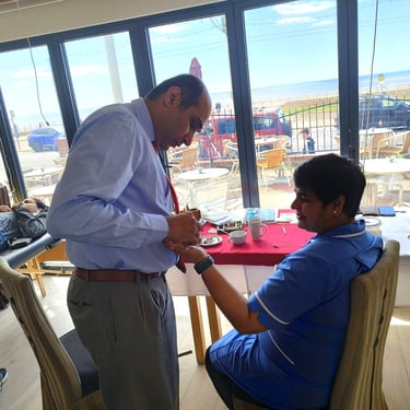 Treating a uniformed NHS medical professional for occupational pain at a Blackpool clinic.