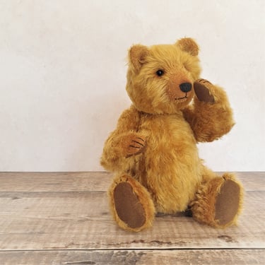 a handmade teddy bear sitting on a table