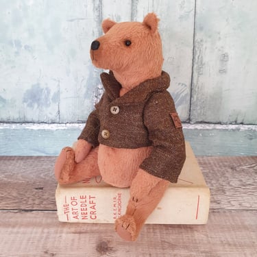 a handmade teddy bear wearing a handmade wool tweed jacket from a vintage british woollen mill