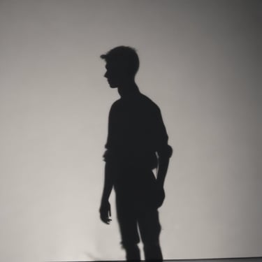 a man standing in front of a wall with a skateboard