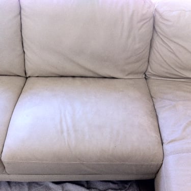 dirty light beige leather sofa close up