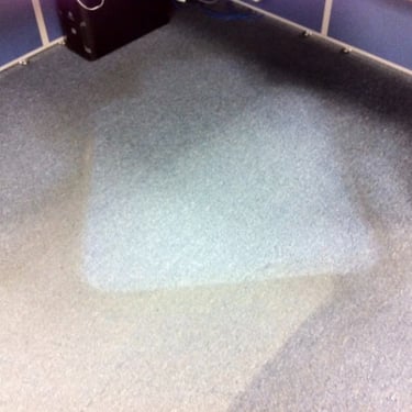 heavily soiled commercial carpet under an office desk