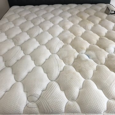 queen size mattress with brow and a blue stain just before professional mattress cleaning