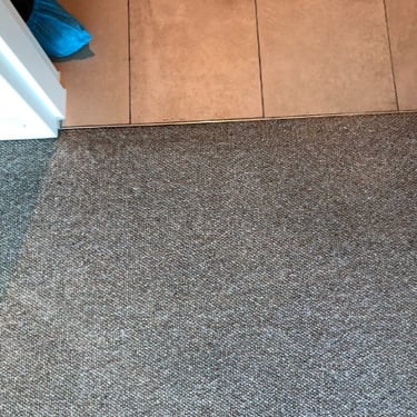 Grey carpet professionally cleaned of oily stains.