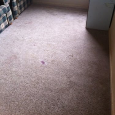old carpet with red ink stain