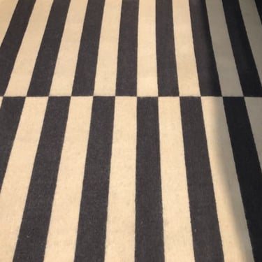 black and white stripped rug with stains removed by a professional carpet cleaner