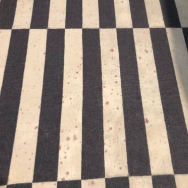 black and white stripped rug with wine spills