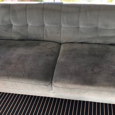 heavily soiled 2-seater green sofa before professional sofa cleaning