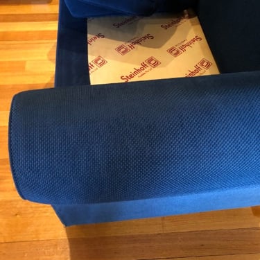closed up of a clean blue sofa armrests after professional sofa cleaning