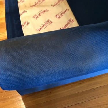 close up of a heavily soiled armrests of a blue armchair